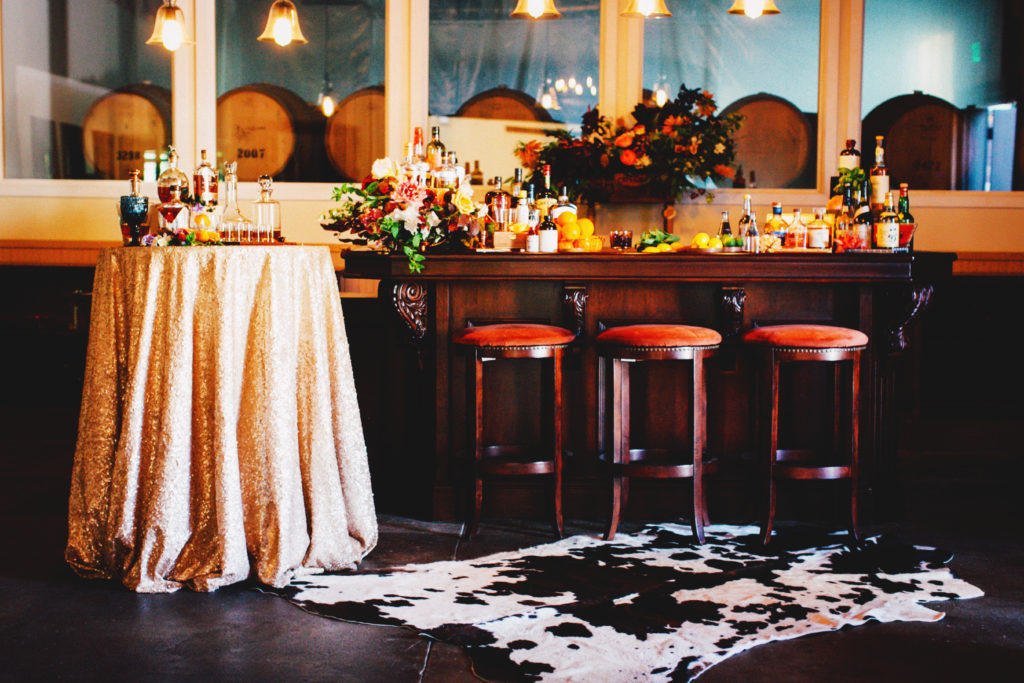 Setting up a bar for a whiskey tasting party by Sacramento event planner, KMK Design. 