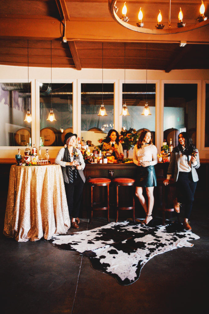 Women standing at a bar during a whiskey tasting party hosted by Sacramento event planner, KMK Design. 